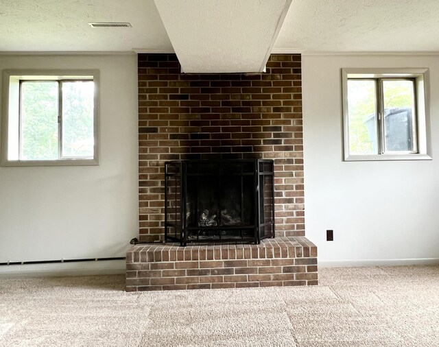 unfurnished living room with a brick fireplace, a textured ceiling, and carpet flooring