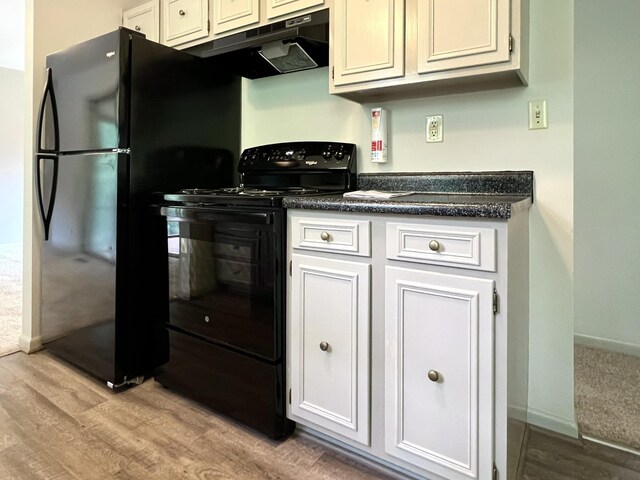 kitchen with white cabinets, light wood-type flooring, and black appliances