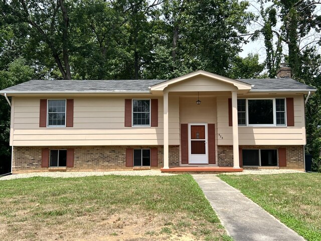 split foyer home with a front lawn