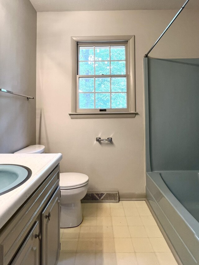 full bathroom featuring shower / tub combination, vanity, and toilet