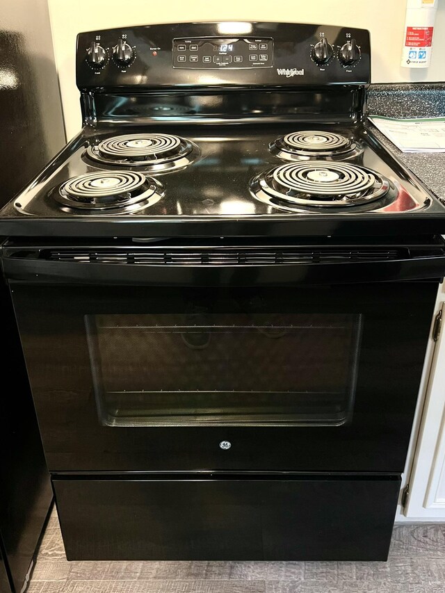 details with white cabinetry and electric range