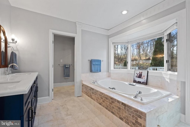 bathroom featuring vanity and tiled bath