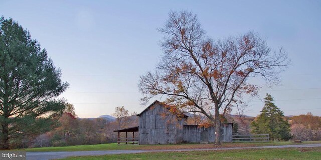 exterior space featuring a barn and a mountain view