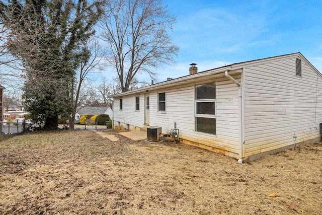 rear view of house featuring central AC