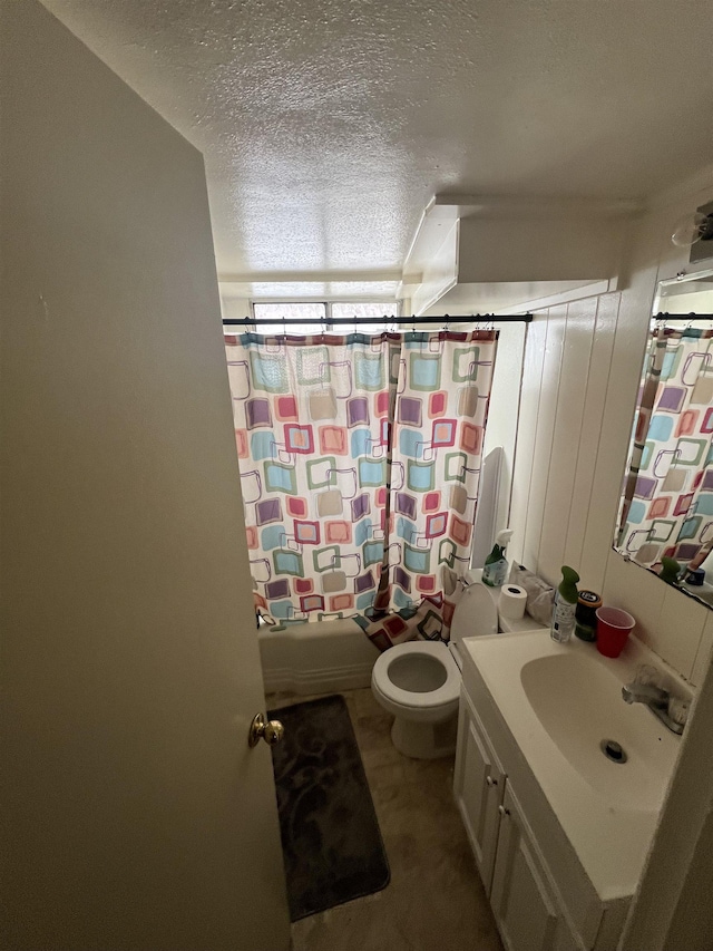 full bathroom with shower / bath combination with curtain, vanity, toilet, and a textured ceiling