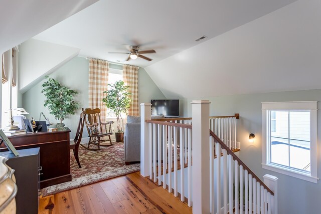 interior space featuring ceiling fan, lofted ceiling, plenty of natural light, and wood-type flooring