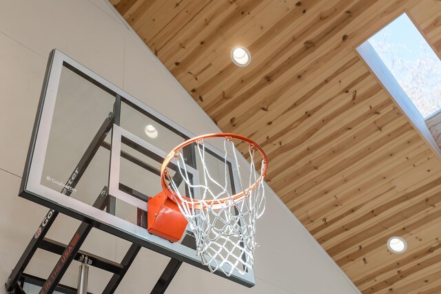 room details with a skylight, wooden ceiling, and wooden walls