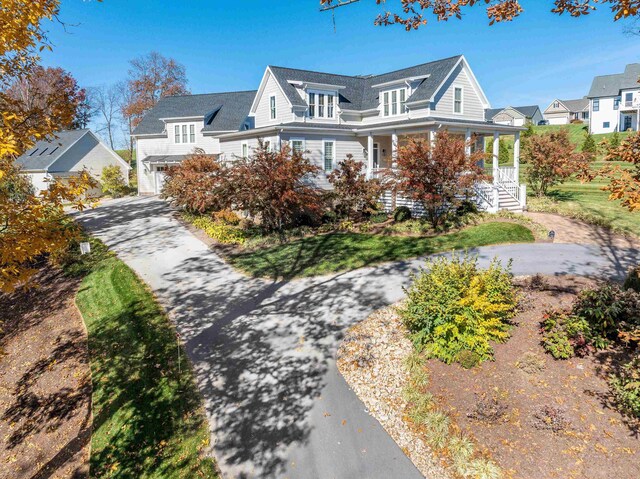 view of front facade with a garage and covered porch