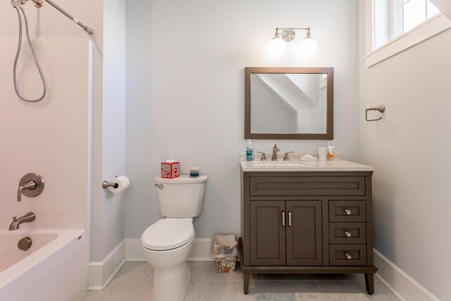 full bathroom with toilet, vanity, and shower / washtub combination