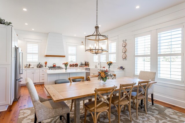 dining area with a notable chandelier and light wood-type flooring