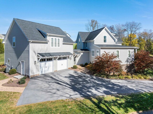 view of property with cooling unit and a garage