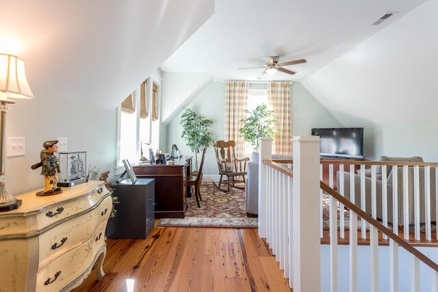 interior space featuring vaulted ceiling and light hardwood / wood-style flooring