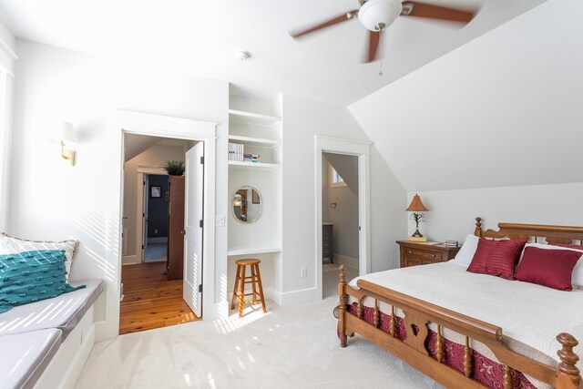 carpeted bedroom with vaulted ceiling and ceiling fan