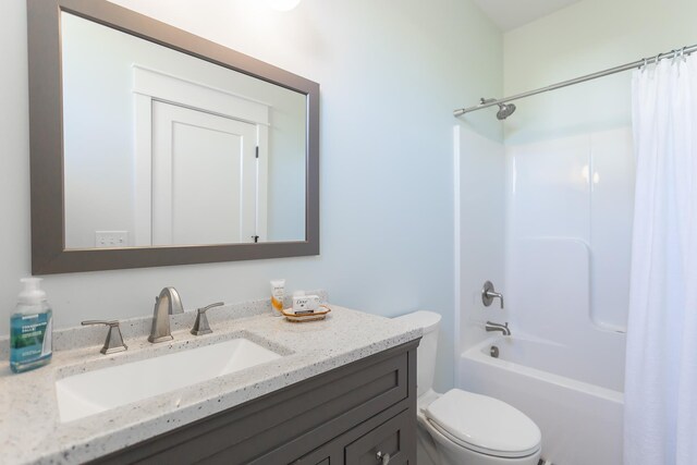 full bathroom featuring vanity, shower / tub combo with curtain, and toilet