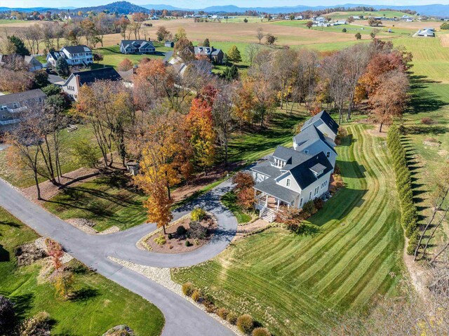 birds eye view of property with a rural view