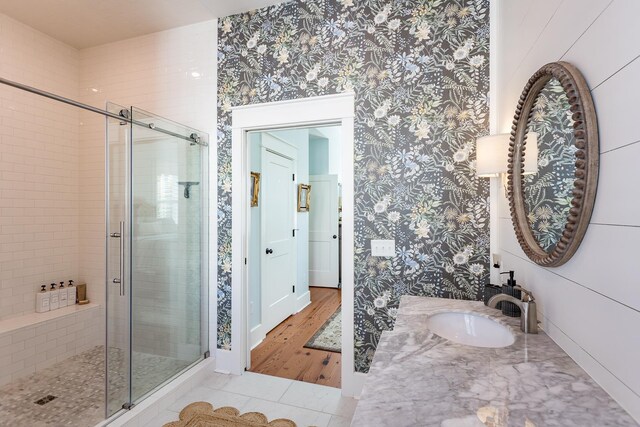 bathroom featuring sink and an enclosed shower