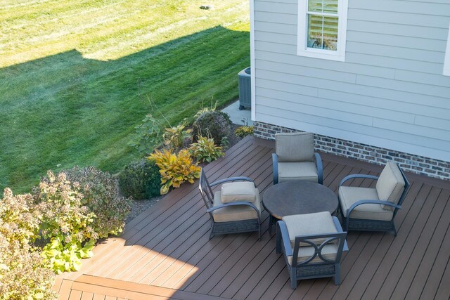 wooden terrace with a lawn and central air condition unit