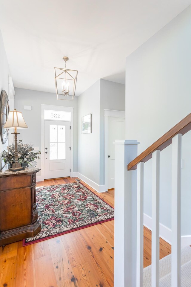 foyer with a notable chandelier and light wood-type flooring