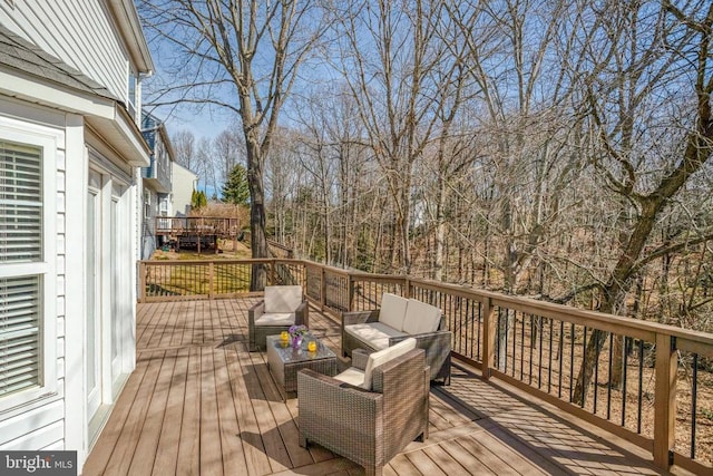 wooden terrace featuring an outdoor hangout area