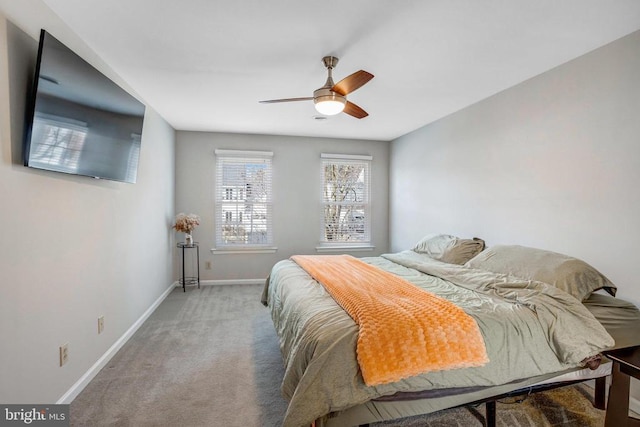 bedroom with a ceiling fan, carpet, and baseboards