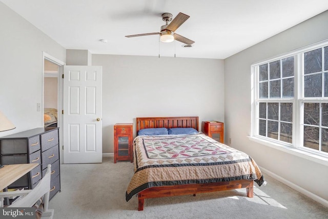 carpeted bedroom with baseboards, multiple windows, and ceiling fan