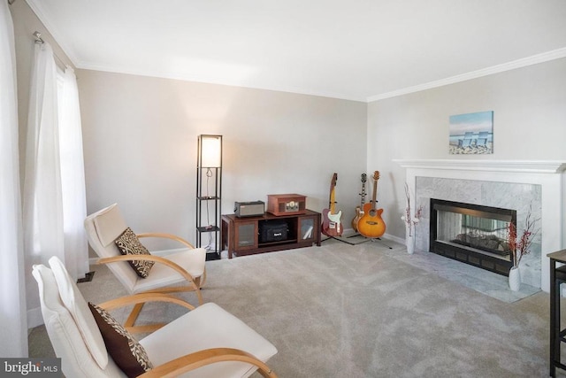 sitting room with carpet, ornamental molding, and a fireplace