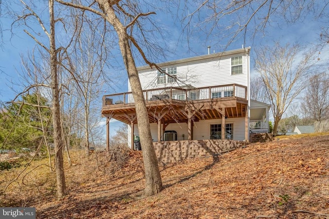 rear view of property with a wooden deck