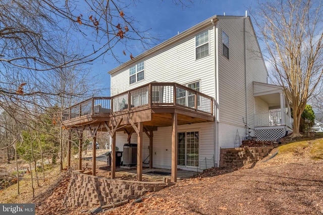 back of house featuring central AC and a wooden deck