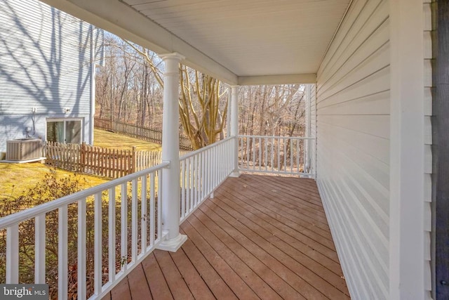 wooden deck featuring cooling unit