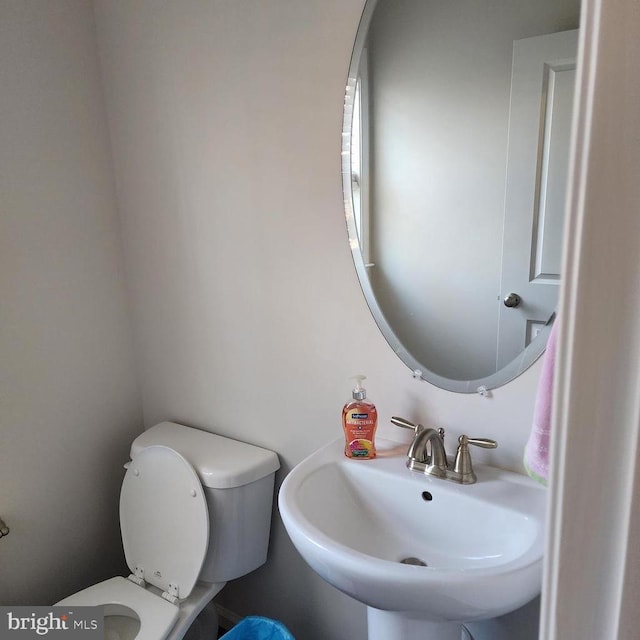 bathroom with toilet and a sink