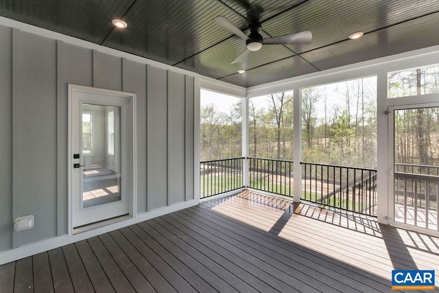 unfurnished sunroom with ceiling fan