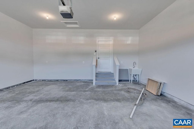 garage with sink and a garage door opener