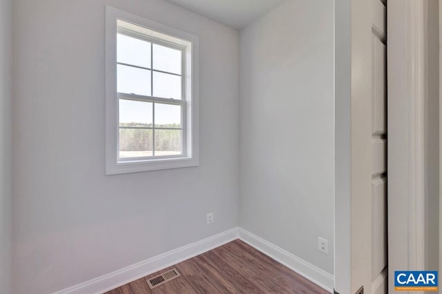 spare room with dark hardwood / wood-style floors