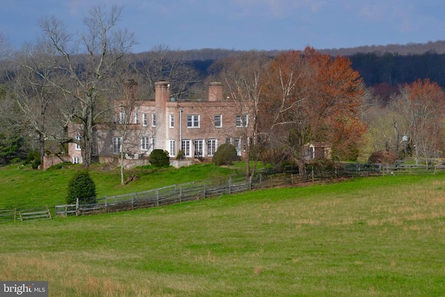 exterior space with a front yard and a rural view