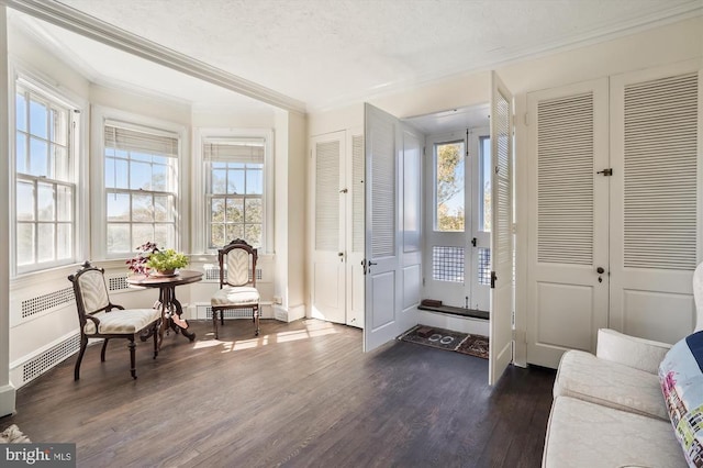 interior space with dark hardwood / wood-style flooring and ornamental molding