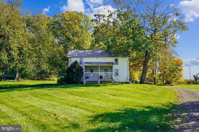 view of front of home with covered porch and a front yard