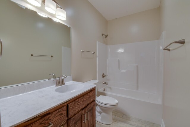 bathroom with toilet, vanity, and bathtub / shower combination