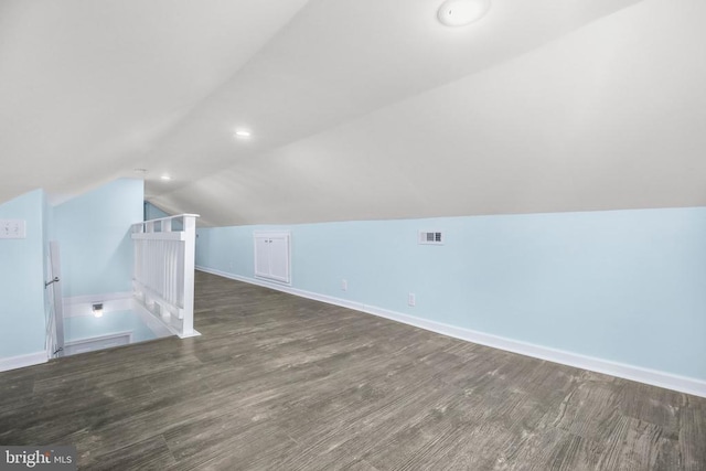 additional living space featuring visible vents, wood finished floors, recessed lighting, baseboards, and vaulted ceiling