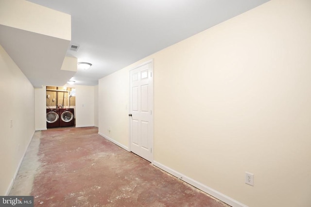 finished below grade area featuring visible vents, washing machine and dryer, and baseboards