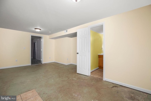 empty room featuring visible vents, concrete flooring, and baseboards