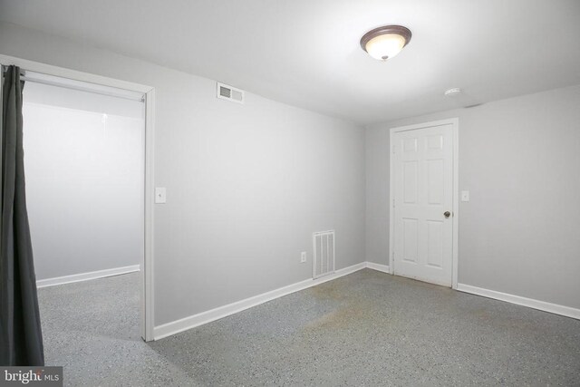 empty room with baseboards and visible vents