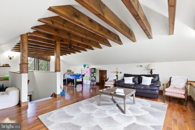 living room with hardwood / wood-style flooring and lofted ceiling with beams