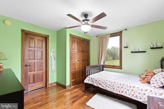 bedroom with ceiling fan, dark hardwood / wood-style flooring, and a closet