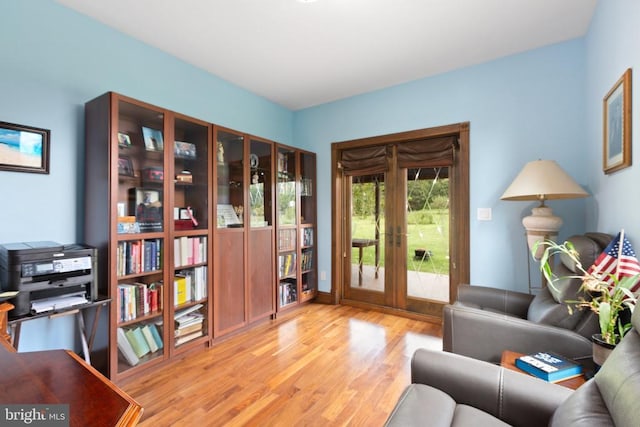 sitting room with light hardwood / wood-style flooring and french doors