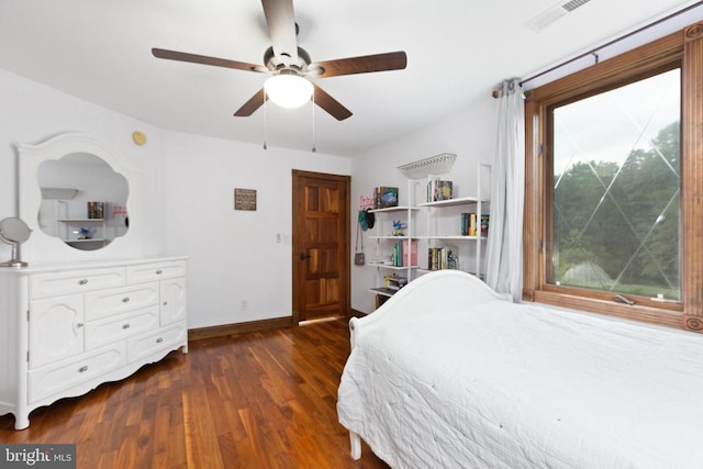 bedroom with dark hardwood / wood-style floors and ceiling fan