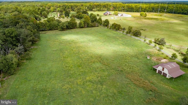 birds eye view of property with a rural view