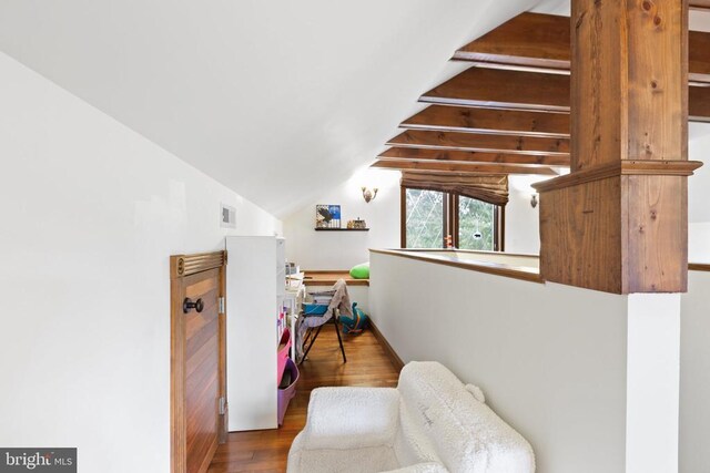 interior space featuring lofted ceiling and hardwood / wood-style floors