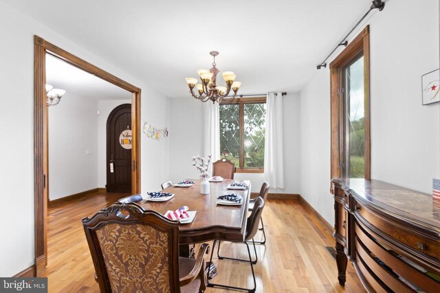 dining room featuring a chandelier and light hardwood / wood-style flooring