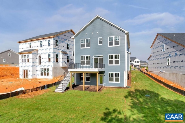 rear view of property with a yard and a deck