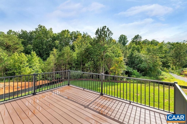 wooden deck featuring a yard